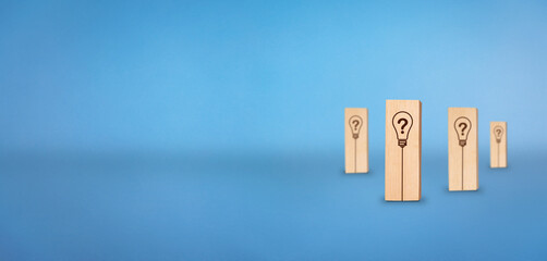 Question mark concept. Wooden block with bulb and question mark icon. Solution concept.