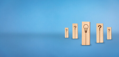Question mark and Solution concept. Wooden block with bulb indicating solution.  