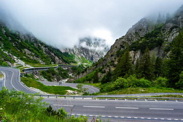 High altitude serpentine mountain pass in the Swiss alps Oberalppass top view cloudy summer day