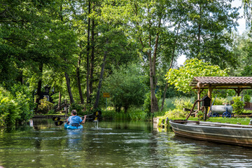 Fototapeta na wymiar Boats on the water canal in biosphere reserve Spree forest (Spreewald) in the state of Brandenburg, Germany
