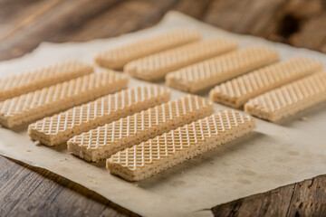 Heap of wafers in plate on an old wooden table