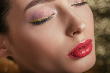 Fototapeta premium close up view of beautiful woman with shiny makeup and closed eyes