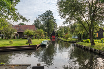 Fototapeta na wymiar House at a crossover of water canals in biosphere reserve Spree forest (Spreewald) in Germany