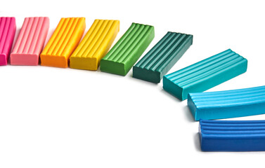 Set of multi-colored pieces of plasticine on a white background with place for text.