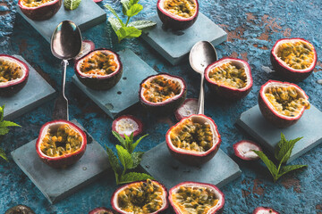 top view of fresh ripe delicious passion fruits with mint leaves