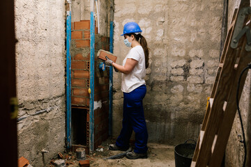 woman with a mask working on a house renovation