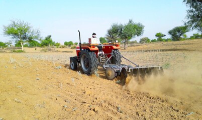A tractor working in a field agriculture activities