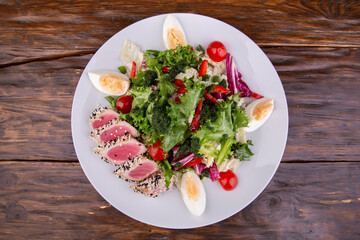 Vegetable salad with tuna, boiled egg, tomatoes and greens