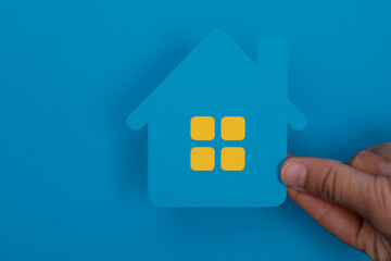 imply flat lay design with miniature white toy house