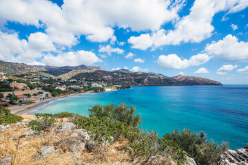 
Coast of a greek island in the mediterranean sea. A bay with beautiful blue clear water, with a beach, on a background of mountains.