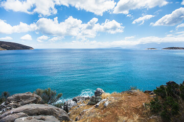 Coast of Crete, Greece. Blue waters of  Mediterranean Sea and blue sky with clouds.