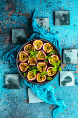 top view of fresh ripe delicious passion fruits with mint leaves