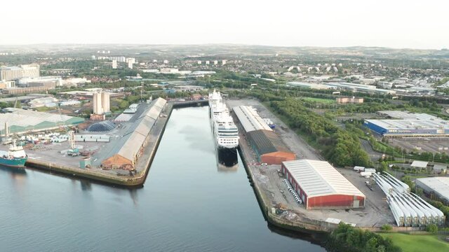 A wide panning drone shot of the three Azamara cruise ships docked on the River Clyde in Glasgow