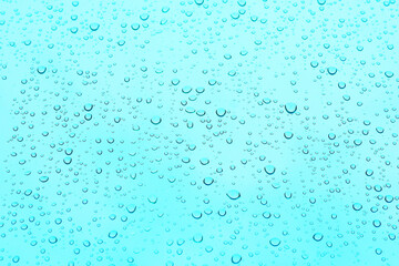 .background and texture of a drop of water on blue glass.