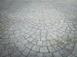 Gray cobblestone bricks floor with a curve of half-circle pattern as background texture. - obrazy, fototapety, plakaty