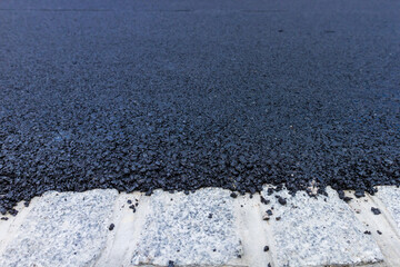 Fresh black asphalt on new street road. Construction at work.
