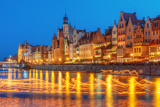 Fire show on Motlawa River during Fair St. Dominic in Gdansk at night, Poland