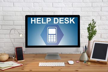 Modern computer and stationery on wooden table. Help desk service