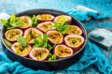 top view of fresh ripe delicious passion fruits with mint leaves