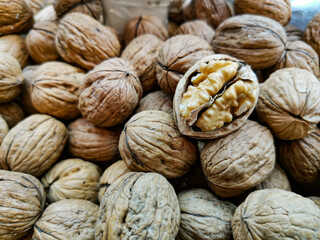 Closeup of shelled peeled walnut on a farmer's market counter. Background of nuts. Healthy nutrition and vitamins. 