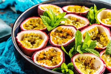 top view of fresh ripe delicious passion fruits with mint leaves