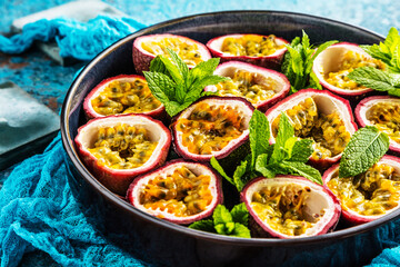 top view of fresh ripe delicious passion fruits with mint leaves