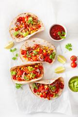 Fototapeta na wymiar mexican beef and pork tacos with salsa, guacamole and vegetables