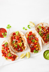 mexican beef and pork tacos with salsa, guacamole and vegetables