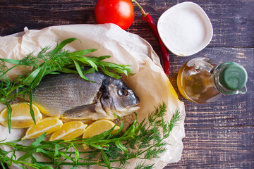 Sea bream fish with lemon, dill, rosemary and tomatoes