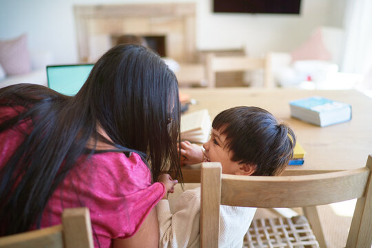 Affectionate mother and son at dining table