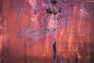 The old iron background is painted in red, pink, purple with rust and chips.