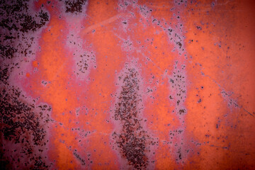 The old iron background is painted in red, pink, purple with rust and chips.