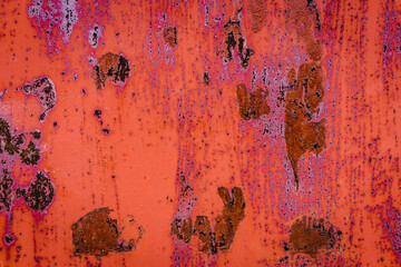 The old iron background is painted in red, pink, purple with rust and chips.
