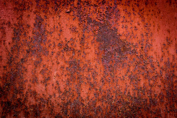 The old iron background is painted in red, pink, purple with rust and chips.