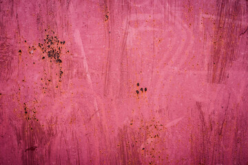 The old iron background is painted in red, pink, purple with rust and chips.