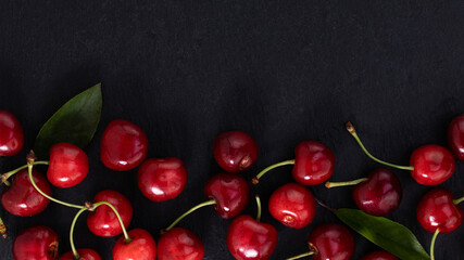 cherry on dark background with copy space. Top view. Flat lay