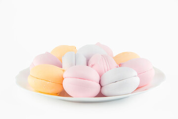 colorful marshmallows and chocolate cookies on a plate, isolate