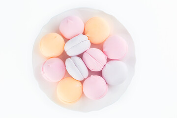 colorful marshmallows and chocolate cookies on a plate, isolate