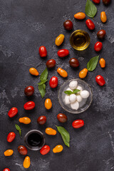 Fototapeta na wymiar Ingredients for caprese salad: tomatoes, mozzarella and basil.
