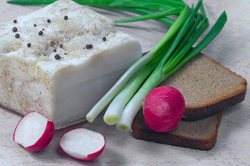 composition with bread, salted bacon, radish and onion on wooden table