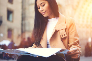 Charming concentrated young hipster girl spending weekends traveling alone in old European town...