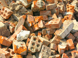 broken bricks lie in a pile in a construction waste dump