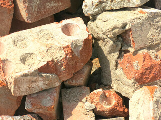 broken bricks lie in a pile in a construction waste dump