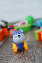 Cute small plastic and wooden toys on dark floor
