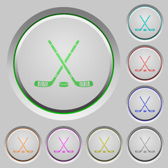 Hockey sticks with puck push buttons