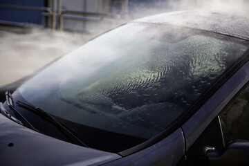 Washing a car with pressurized water