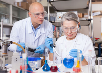 Scientists mixing reagents