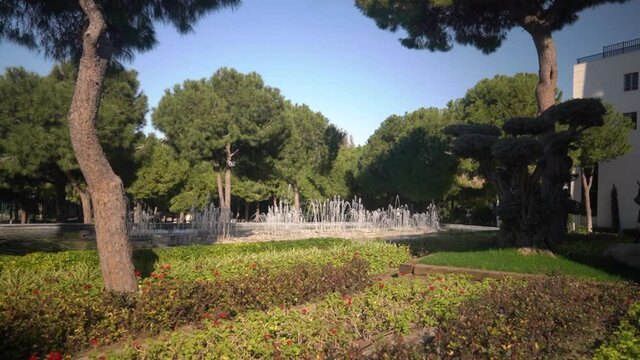 Decorative fountain in a beautiful park . Green trees grow in the background. Landscape design.