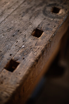 High angle of wooden shabby template with marking square shaped holes for crafting violin details in workroom