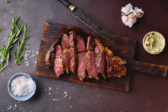 Cooked and cut ribeye black angus prime beef steak.
